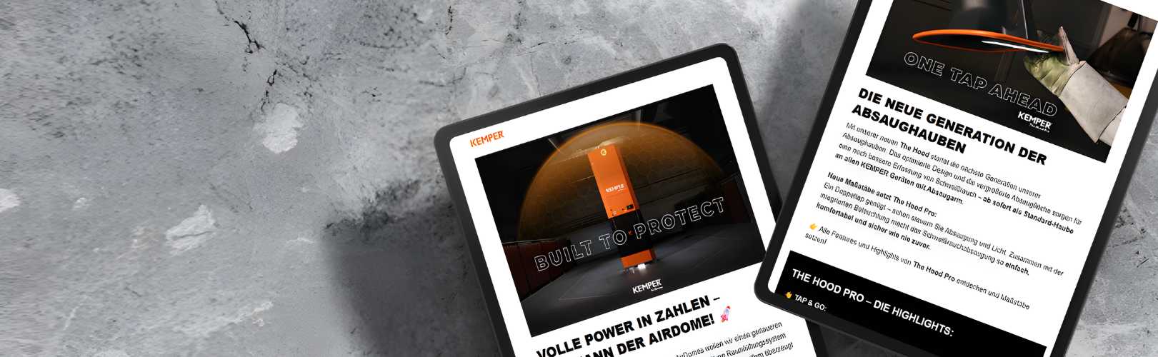 Two tablets displaying the KEMPER newsletter with information about air purification and extraction technology