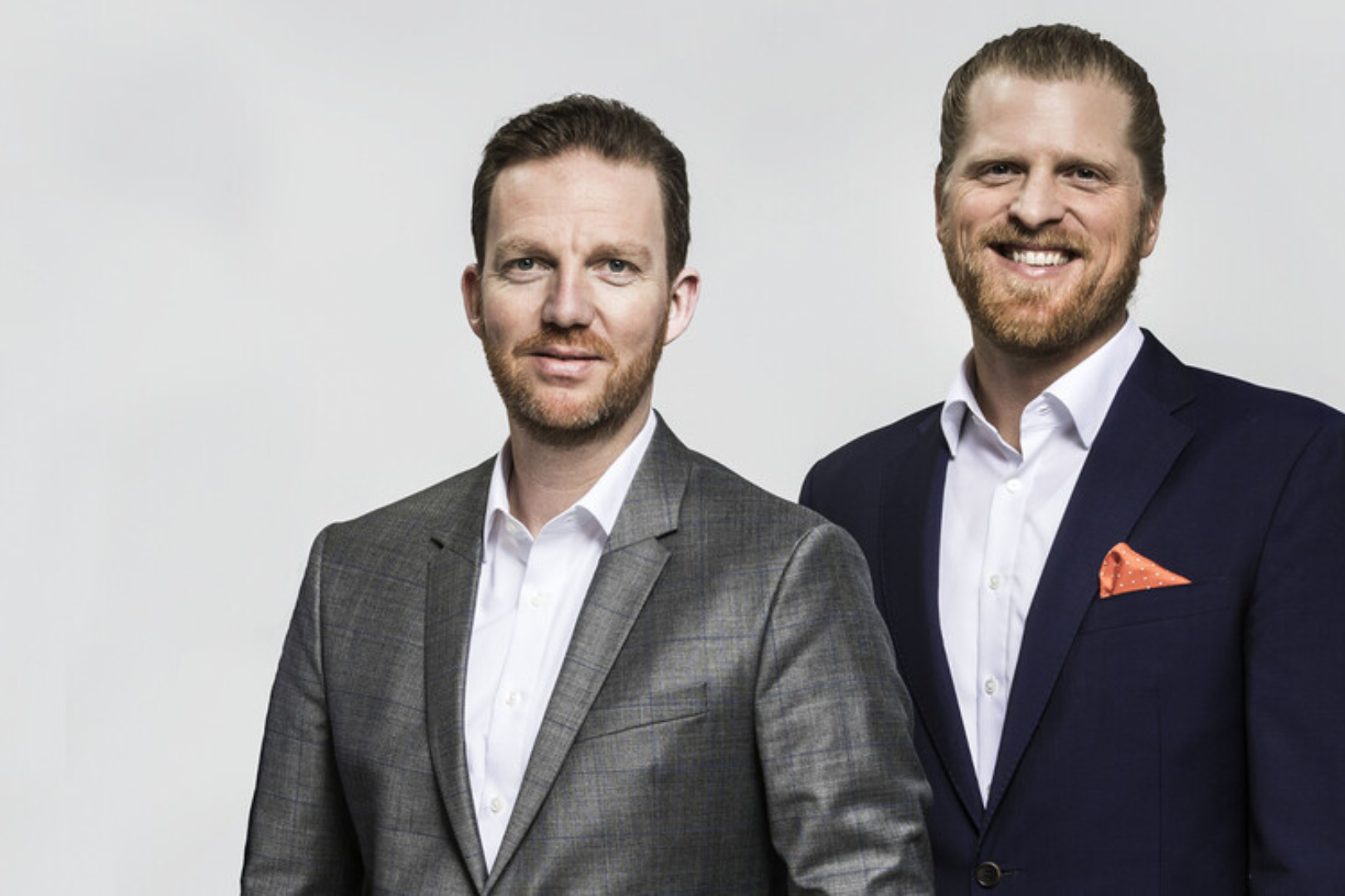 Portrait of the managing directors of KEMPER in business attire against a neutral background