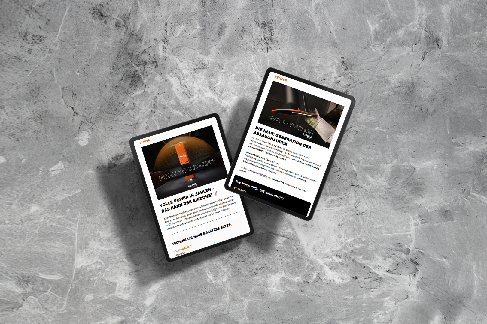 Two tablets displaying the KEMPER newsletter with information about air purification and extraction technology