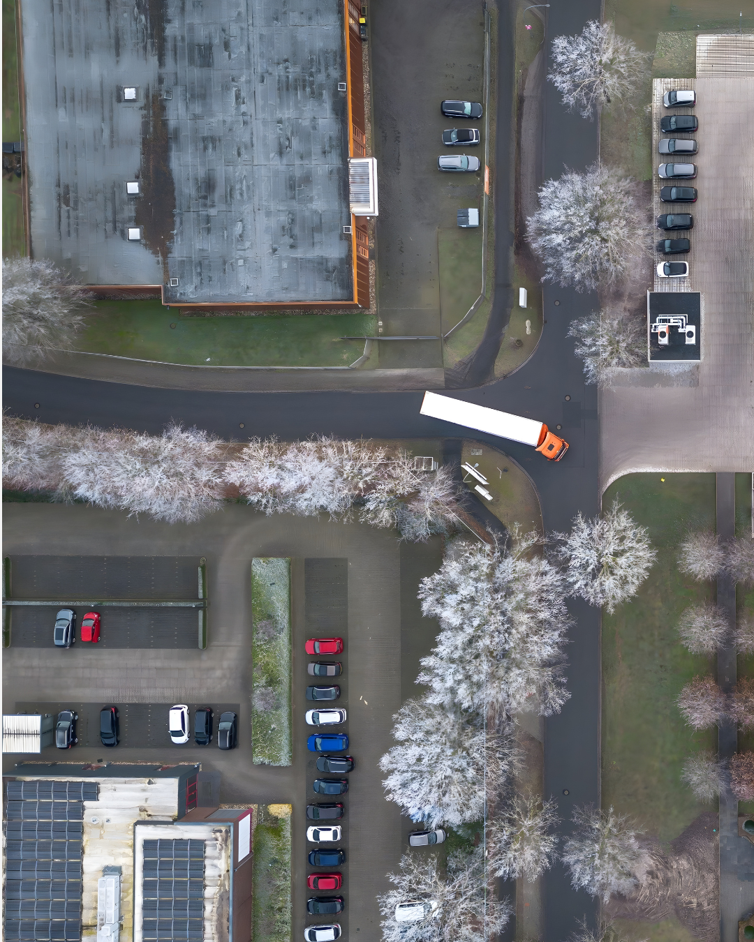 Drone view of the KEMPER company premises with production buildings, parking areas and a truck